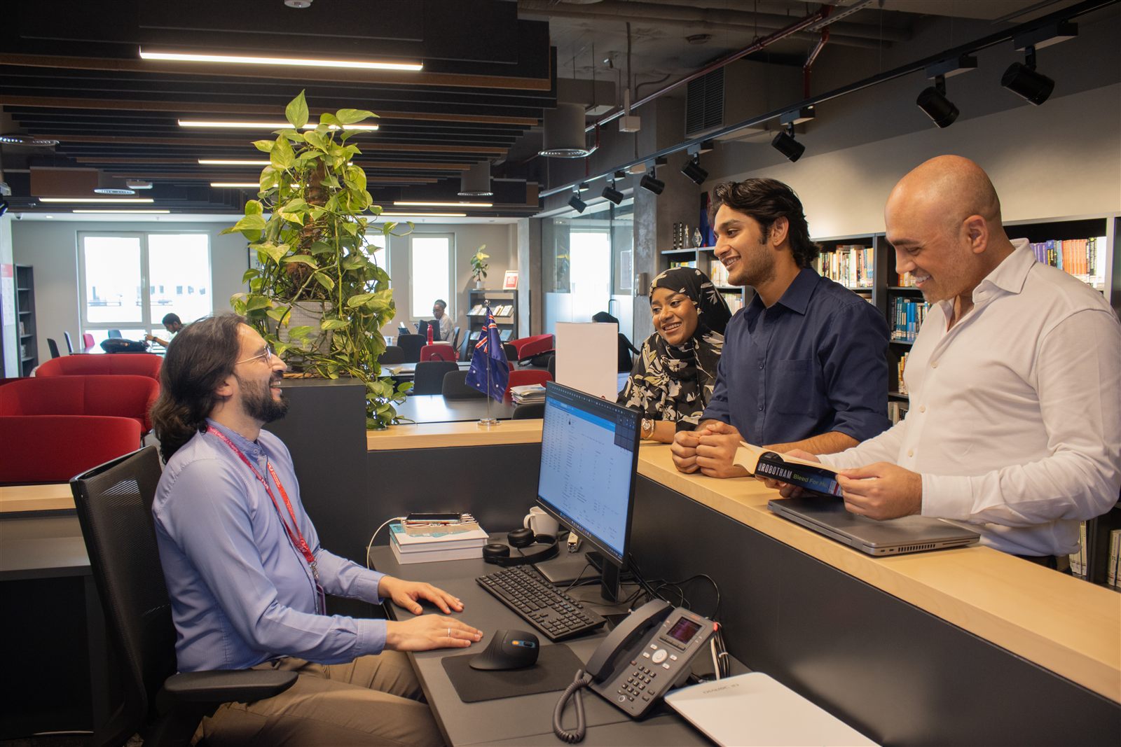 Murdoch University Dubai students completing enrolment with a staff member